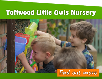 Toftwood Little Owls Nursery - Children playing with plastic toys on a wall. They are in a safe environment